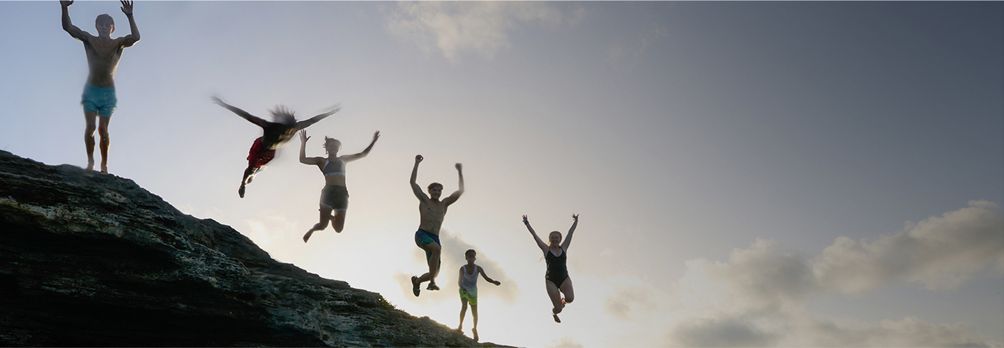 People jumping off a cliff into the water, symbolizing excitement and change