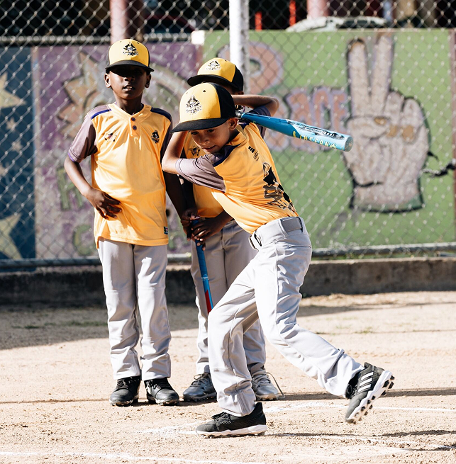 three boys playing cricket
